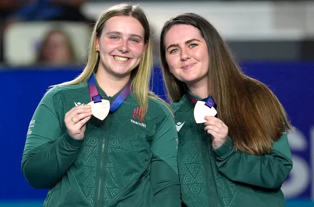 Two Team NI bowlers holding up their medals