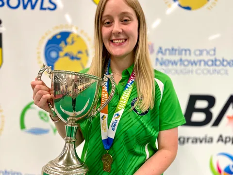 A junior world champion with her trophy and medal