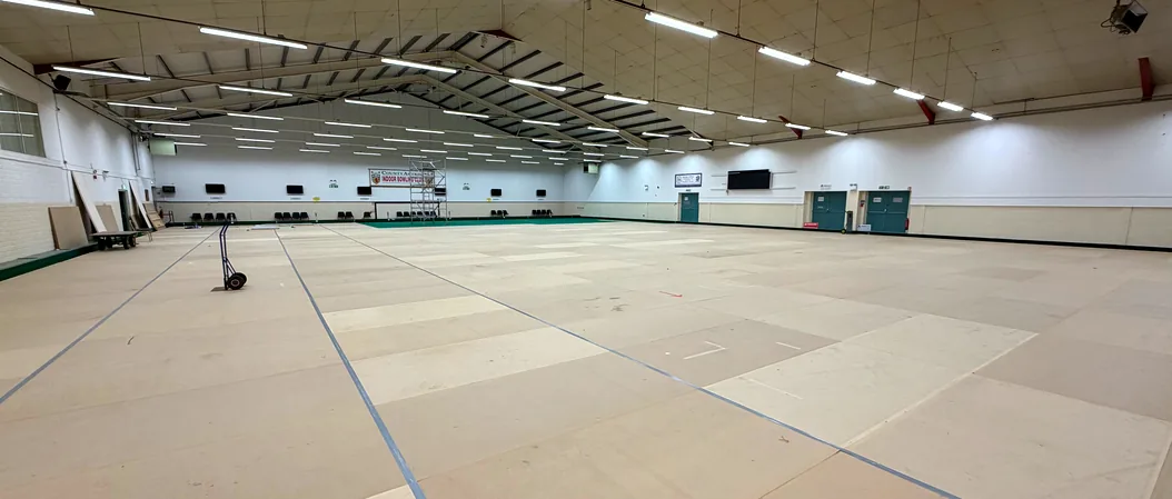 Both greens boarded over, with the walkway between them and the roof of the hall above
