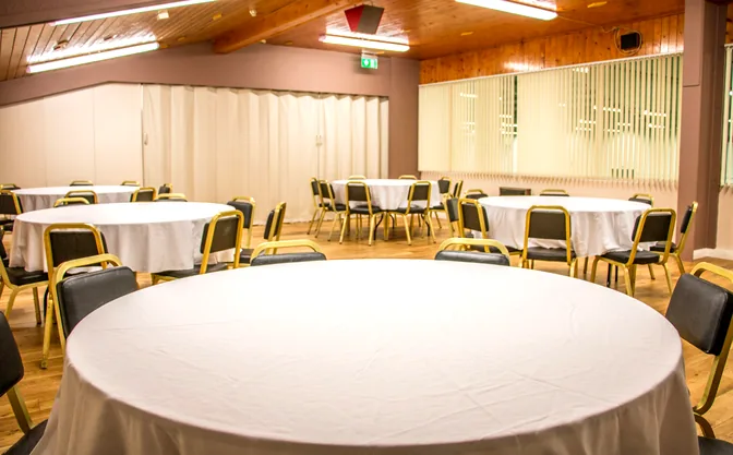 The McConkey Room set with round tables and white linen for a function